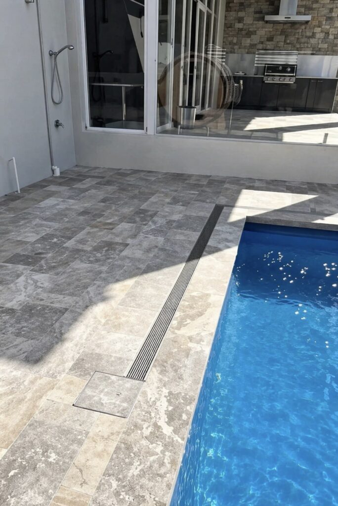 Poolside drainage and paving installation to improve water management. 