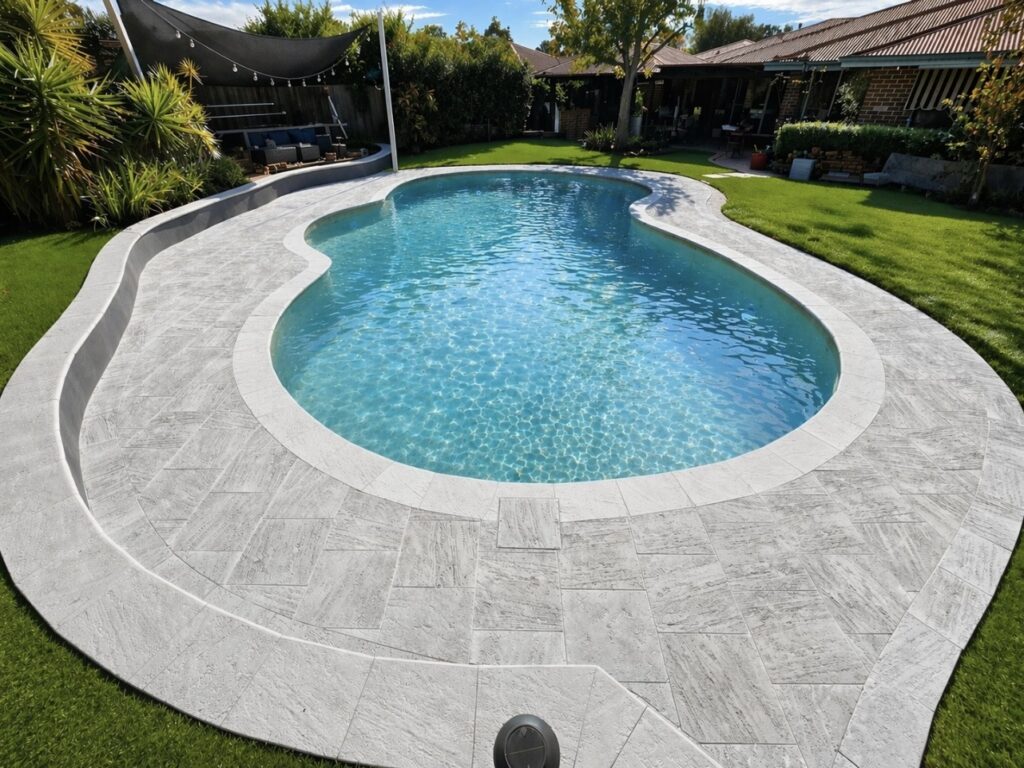 Curved pool surround paving installation and pool capping. 