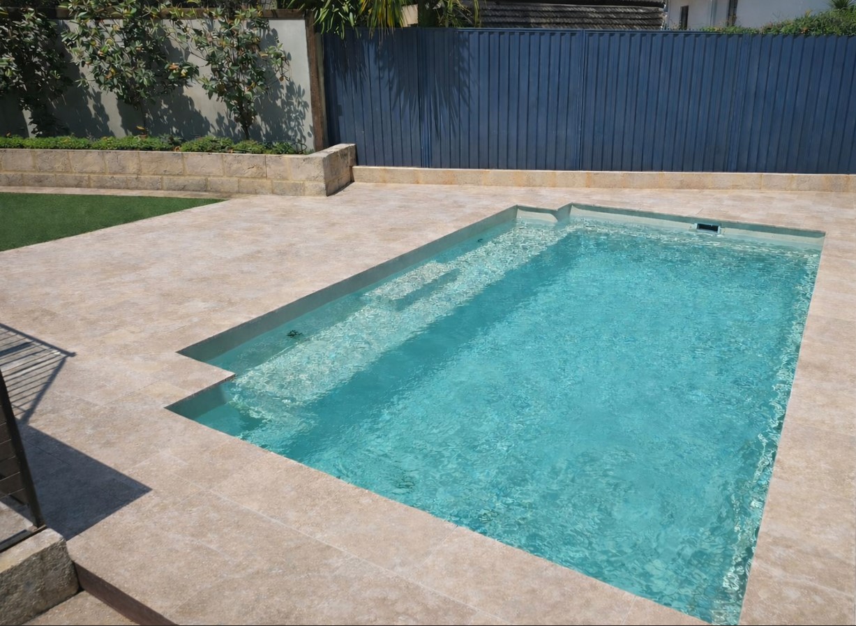 Travertine Pool paving installation with new limestone retaining wall. 
