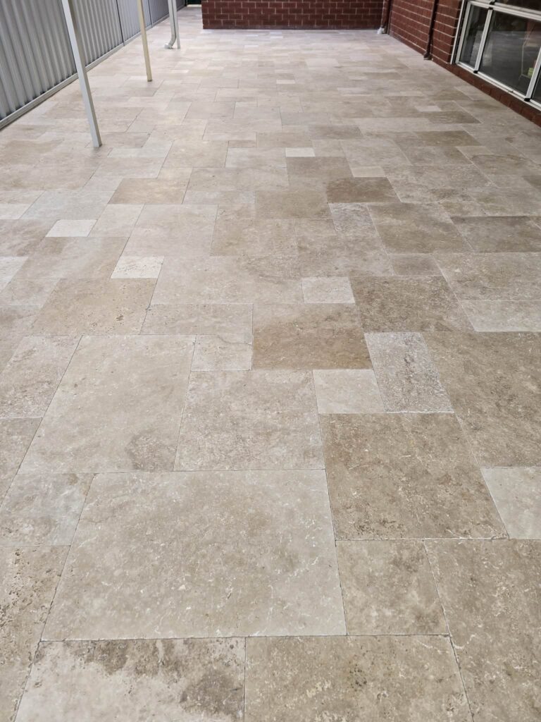 Travertine paving installation for a patio area in Woodvale Perth.