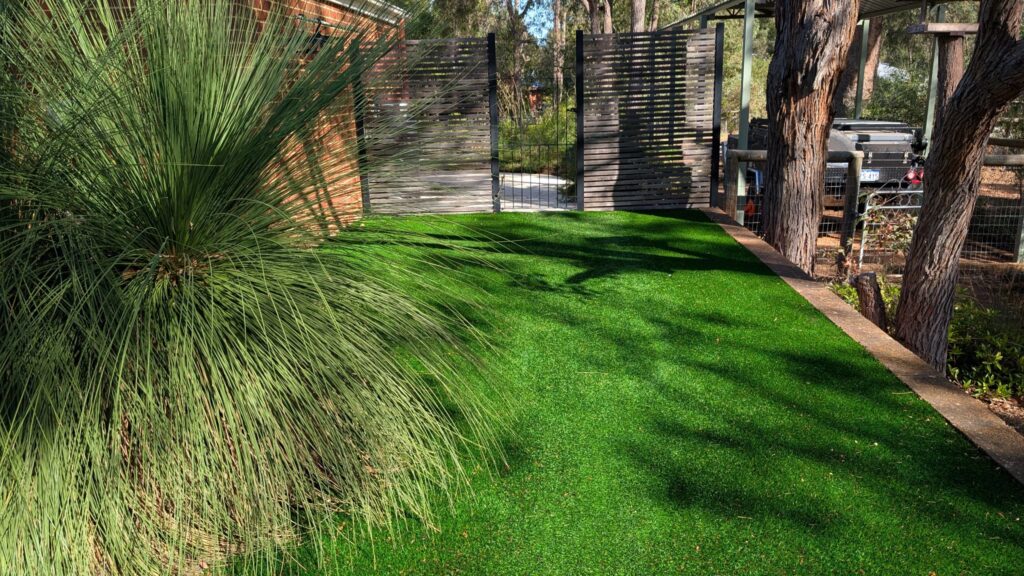 Artificial lawn installation with established trees and feature garden in Mt Helena 